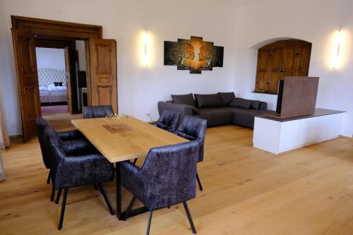 a living room with a table and chairs and a couch at Innviertler Versailles in Aurolzmünster
