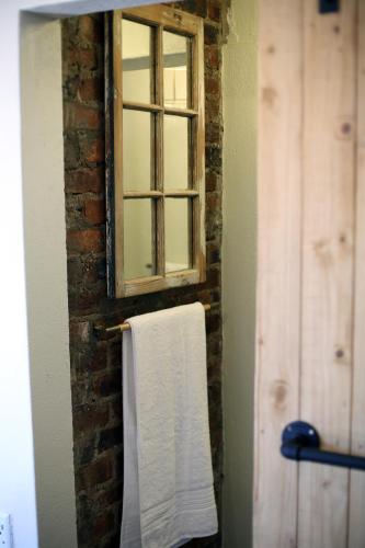 a bathroom with a window and a towel at SOUSIE'S RUSTIC STAY in Polokwane