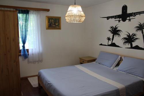 a bedroom with a bed and a plane on the wall at Alamari in Sala