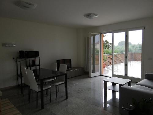a living room with a table and chairs and a couch at Appartamento La Terrazza in Riva del Garda