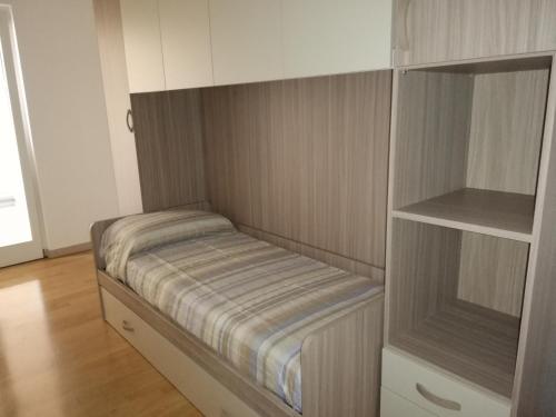 a small room with a bed in a closet at Appartamento La Terrazza in Riva del Garda