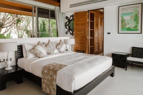 Postel nebo postele na pokoji v ubytování Baan Jakawan
