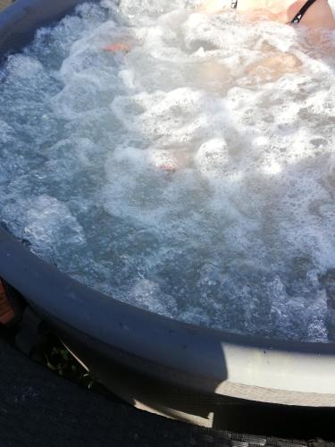 a person is in a jumbopload of boiling water at Glamping Tenuta San Pierino Agriturismo in Rosignano Marittimo