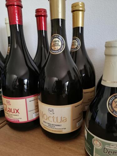four bottles of wine sitting on a table at Glamping Tenuta San Pierino Agriturismo in Rosignano Marittimo