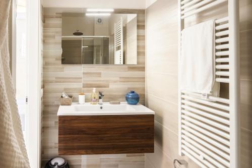 a bathroom with a sink and a mirror at Ca' Ross in Formigine