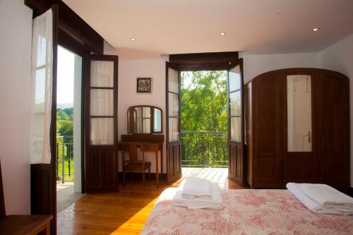 a bedroom with a bed and a large window at Villa Victoria in Vallobal