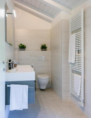 a bathroom with a white sink and a toilet at Ca' Ross in Formigine