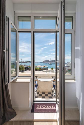 a room with a window with a view of the ocean at Casa Costabella in Split
