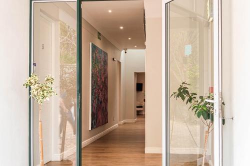 a glass door leading into a hallway with plants at Van der Stel Manor in Stellenbosch