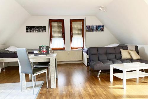a living room with a couch and a table at Schönes 1 Zimmer Apartment mit Dachterrasse in Glauchau