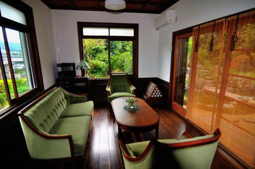 a living room with a couch and chairs and a table at Kotorian in Asuka