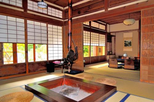 a room with a pool in the middle of a room with windows at Kotorian in Asuka