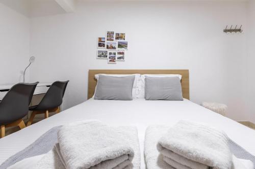 a bedroom with a bed with white sheets and pillows at Αpartment in Rotonda (heart of Thessaloniki) in Thessaloniki