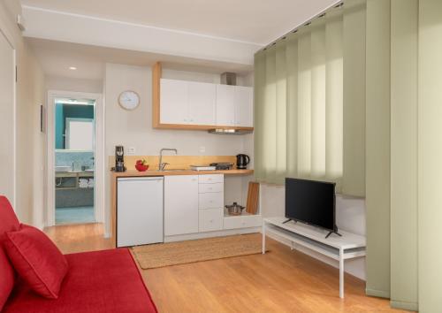 a living room with a kitchen and a tv in it at ASTRA IN CITY in Ioannina