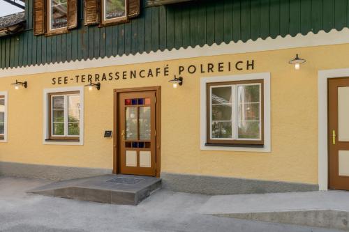 a yellow building with a door in front of it at Polreich Bed&Breakfast in Hallstatt