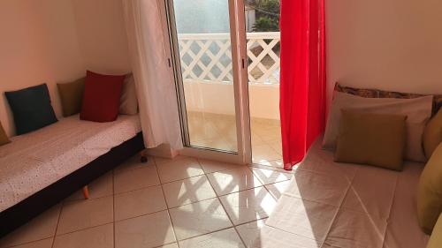 a room with a sliding glass door and a balcony at Santana double bedroom serviced apartment in Santa Maria