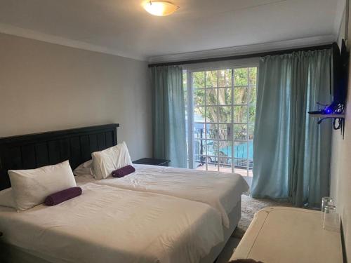 Llit o llits en una habitació de Ndzuti Guest House