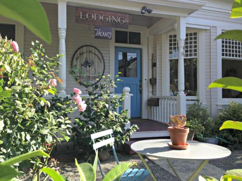 a porch of a house with a table and flowers at An Inn to Remember in Sonoma