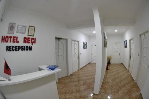 a hallway with a hotel reset reception sign on the wall at Hotel Reci in Peshkopi