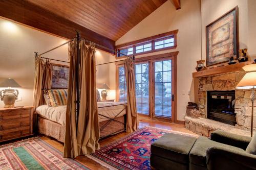 a bedroom with a bed and a fireplace at 7650 Sterling Drive in Park City