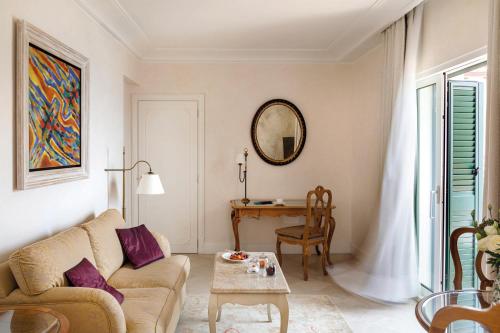 a living room with a couch and a table at Villa Sant'Andrea, A Belmond Hotel, Taormina Mare in Taormina