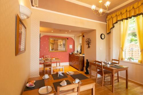 a kitchen and dining room with a table and chairs at The Hill Hotel in Dumfries