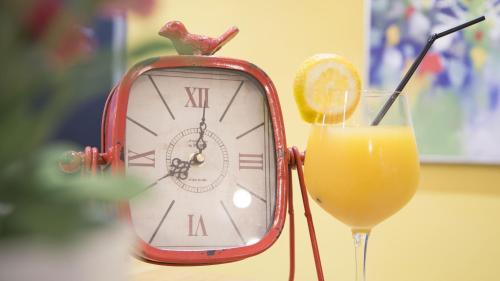 an old red clock and a glass of orange juice at The Best Centric Hotel in Nouakchott