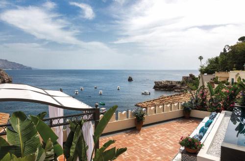 a view of the ocean from a balcony of a resort at Villa Sant'Andrea, A Belmond Hotel, Taormina Mare in Taormina