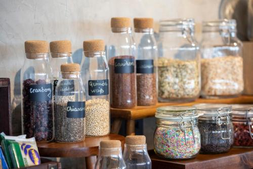 a bunch of glass jars filled with different spices at INNSiDE by Meliá Aachen in Aachen