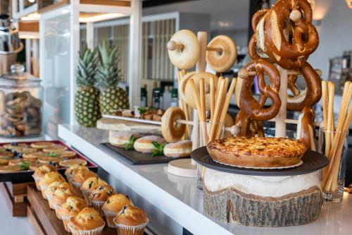 a bakery with a cake and pastries on a counter at INNSiDE by Meliá Aachen in Aachen