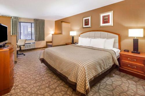 a hotel room with a bed and a flat screen tv at Quality Inn & Suites in Richfield