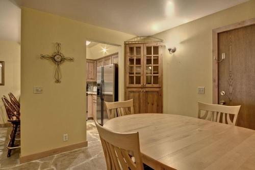 a kitchen with a table and chairs and a refrigerator at Empire Coalition #106 in Park City