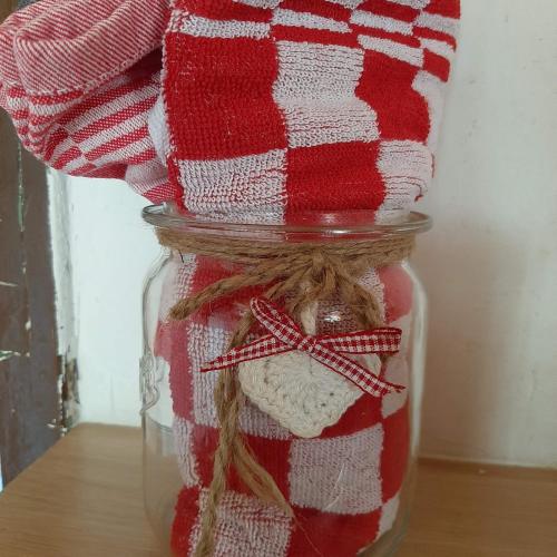 a mason jar filled with a red and white striped towel at Sachserhof Ferienwohnungen in Sachsenburg in Sachsenburg
