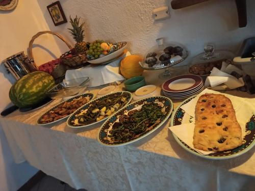 a table with many plates of food on it at Residenza Villa Spagnola in Parghelia