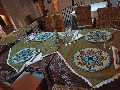 a table with plates and wine glasses on it at Residenza Villa Spagnola in Parghelia