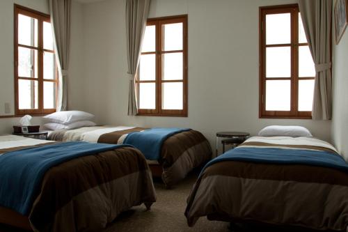 Ένα ή περισσότερα κρεβάτια σε δωμάτιο στο Hakuba House