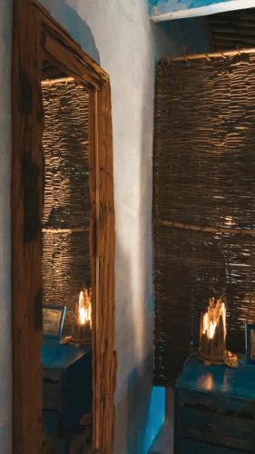 a mirror in a room with some candles in it at Pousada Spa Oasis in Caraíva
