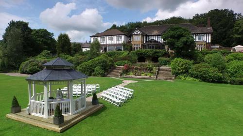 a mansion with a gazebo and a wedding marquee at Higher Trapp Hotel in Padiham