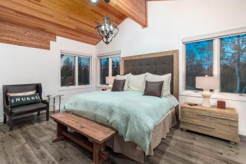 a bedroom with a bed and a chair and windows at Double Eagle #18 in Park City