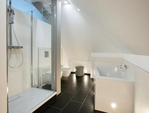 a bathroom with a shower and a toilet and a sink at Wohnperle Apartment Adele in Dresden