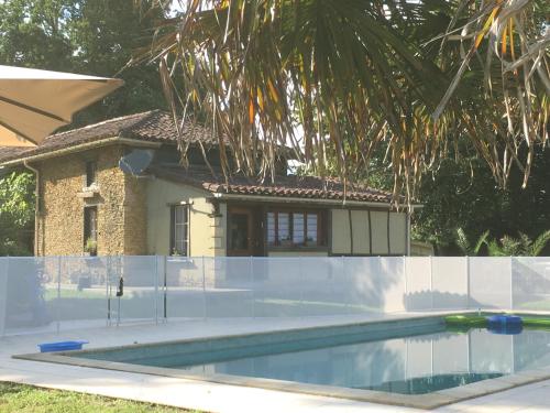 a swimming pool in front of a house at La caseta Domaine du CANTEAU YF in Panjas
