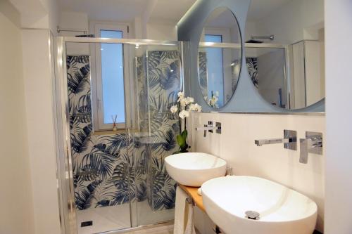 a bathroom with a sink and a mirror at la casa di Gaia in Taormina