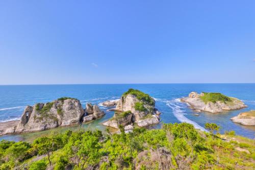 an island in the ocean with rocks in the water at Agva Teras Garden Hotel & Bungalow in Agva