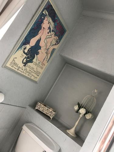 a bathroom with a painting on the wall and a toilet at The Exhibition in York