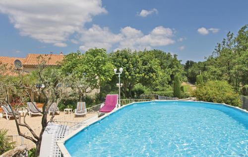 a swimming pool with two chairs and a purplevisorvisor at Pet Friendly Home In Puy Saint Martin in Puy-Saint-Martin