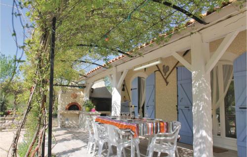 a table and chairs under a pergola at Pet Friendly Home In Puy Saint Martin in Puy-Saint-Martin