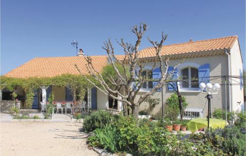 a house with a tree in front of it at Pet Friendly Home In Puy Saint Martin in Puy-Saint-Martin