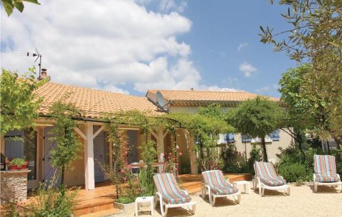 a group of chairs sitting in the yard of a house at Pet Friendly Home In Puy Saint Martin in Puy-Saint-Martin