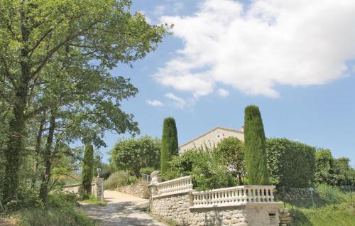 a garden with trees and a building in the background at Pet Friendly Home In Puy Saint Martin in Puy-Saint-Martin