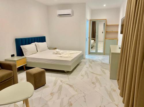 um quarto com uma cama e uma sala de estar em Domi Beach Valley em Dhërmi